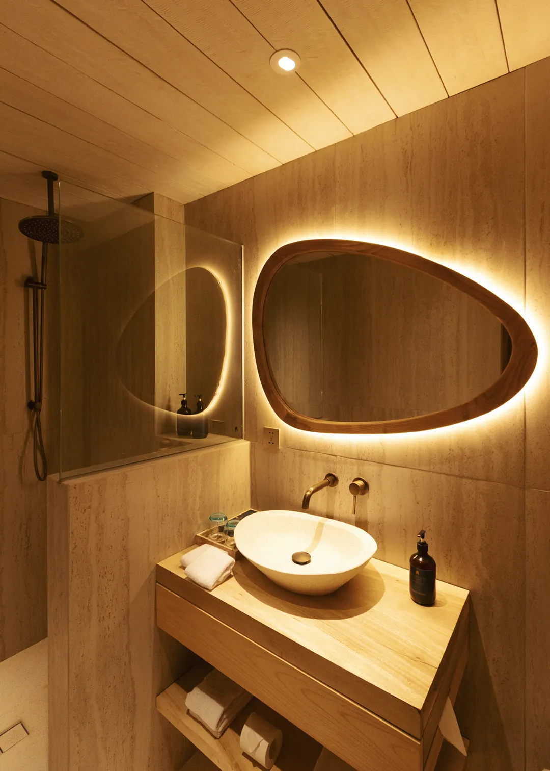 Suite bathroom at Atrium Lombok with stone basin and walk-in shower