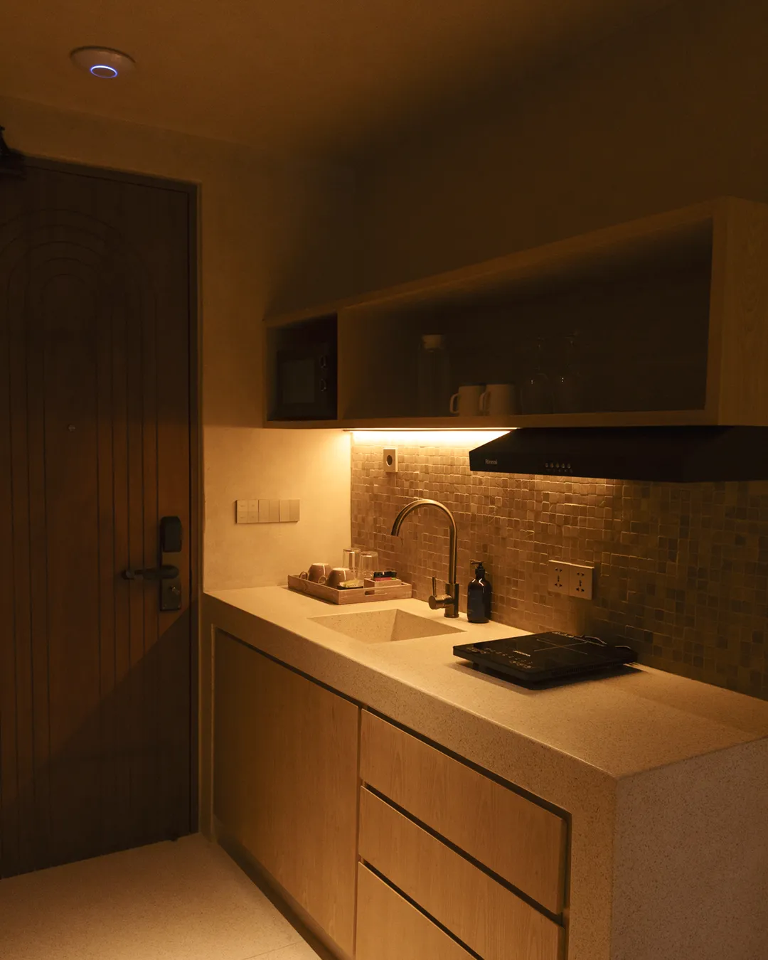 Bed and robe in a suite at Atrium Lombok