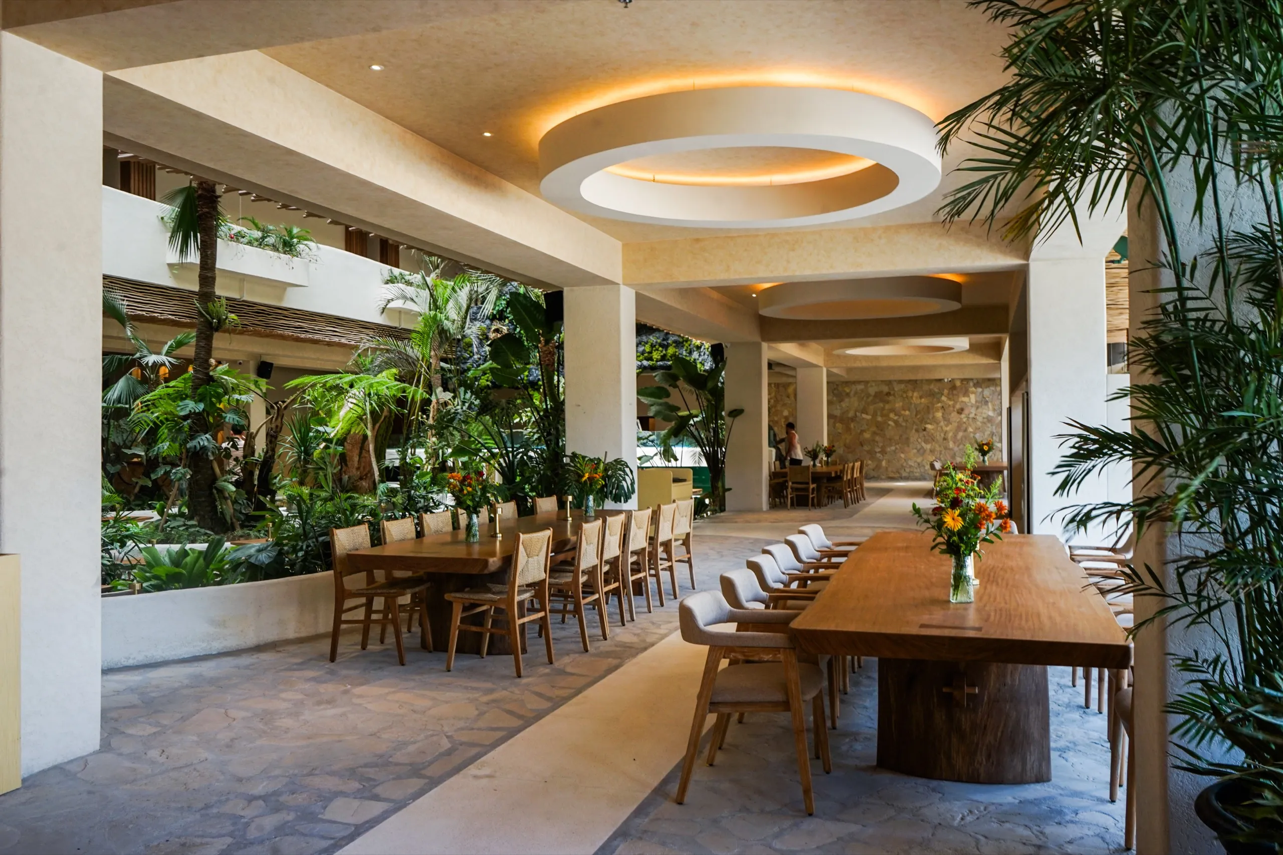 Dining tables set on the ground floor of the atrium