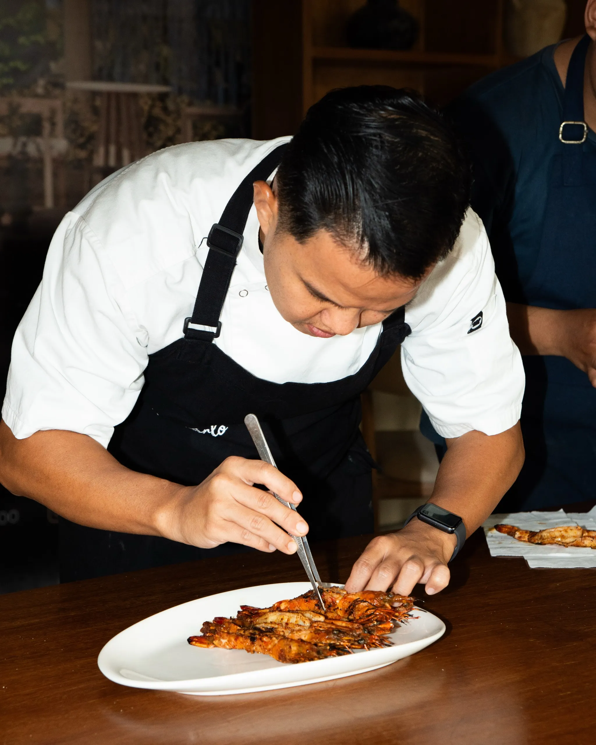 Chef plating a dish in the kitchen