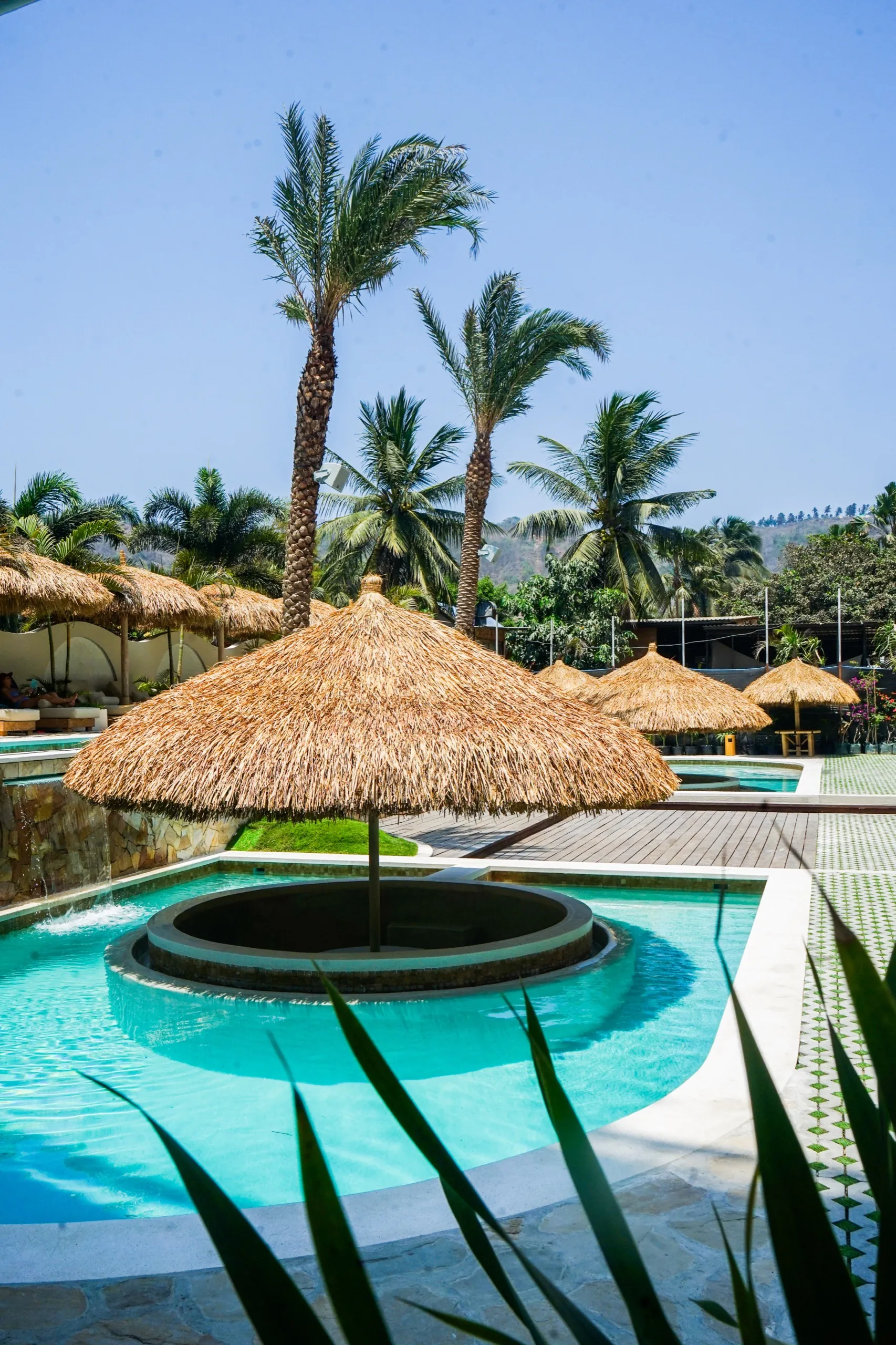 Swimming pool with a shade umbrella and loungers