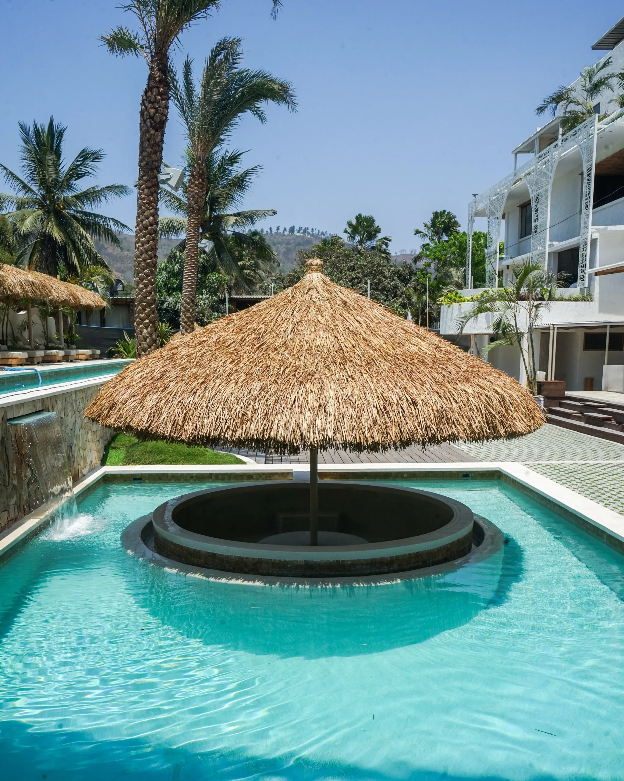 Swimming pool with shade umbrellas and loungers