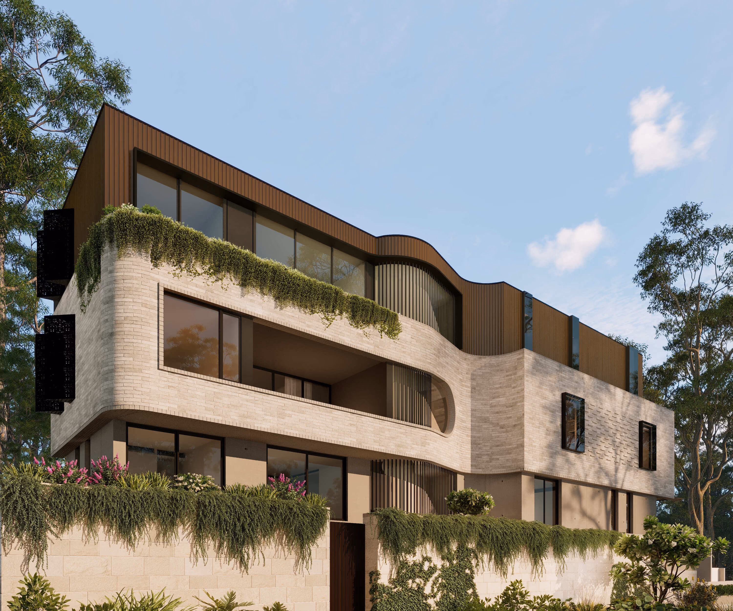 Modern multi-story building with curved balcony, large windows, greenery, and a clear blue sky.