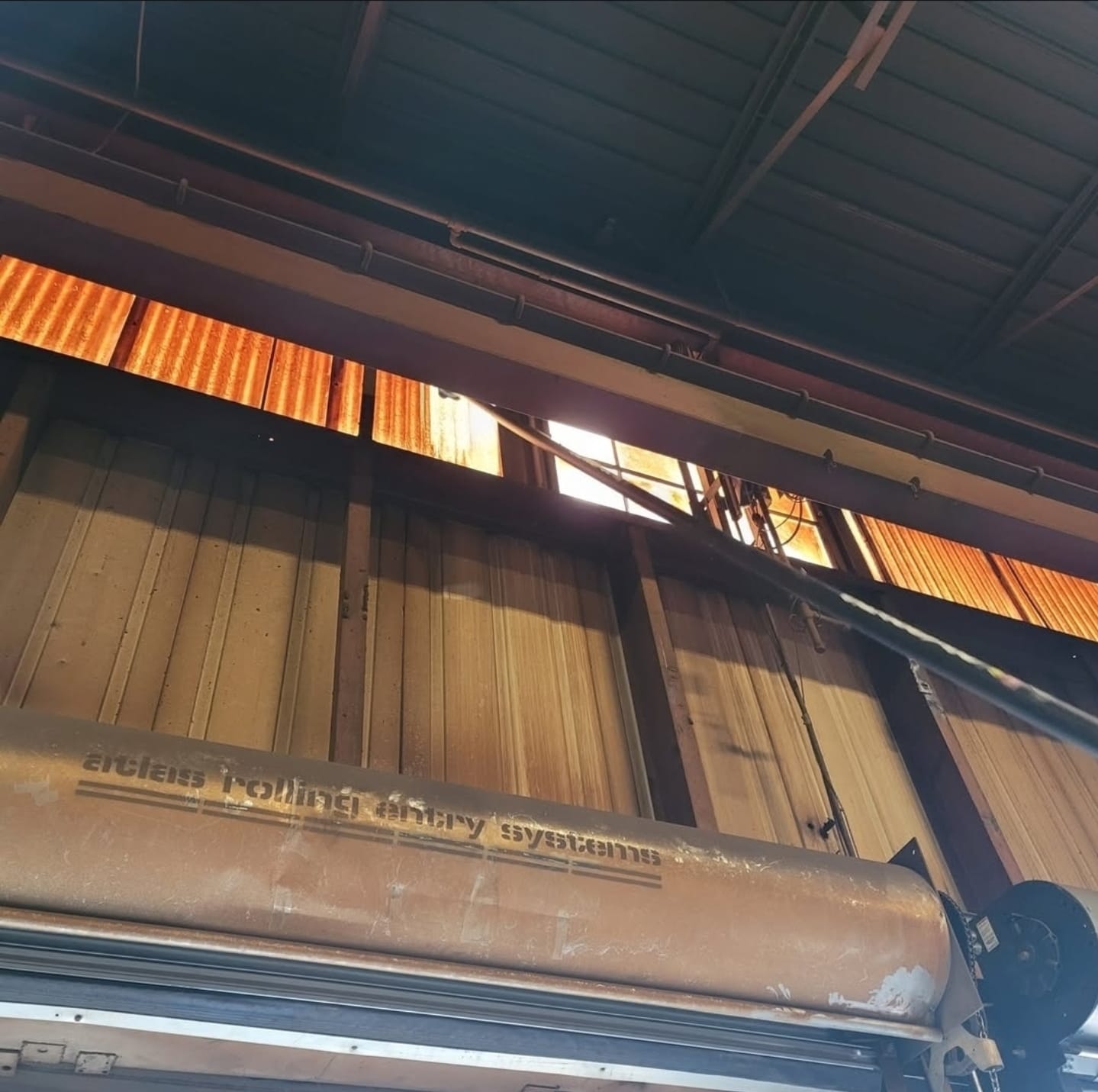 High-level dusting crew cleaning industrial warehouse ceiling structure, GTA