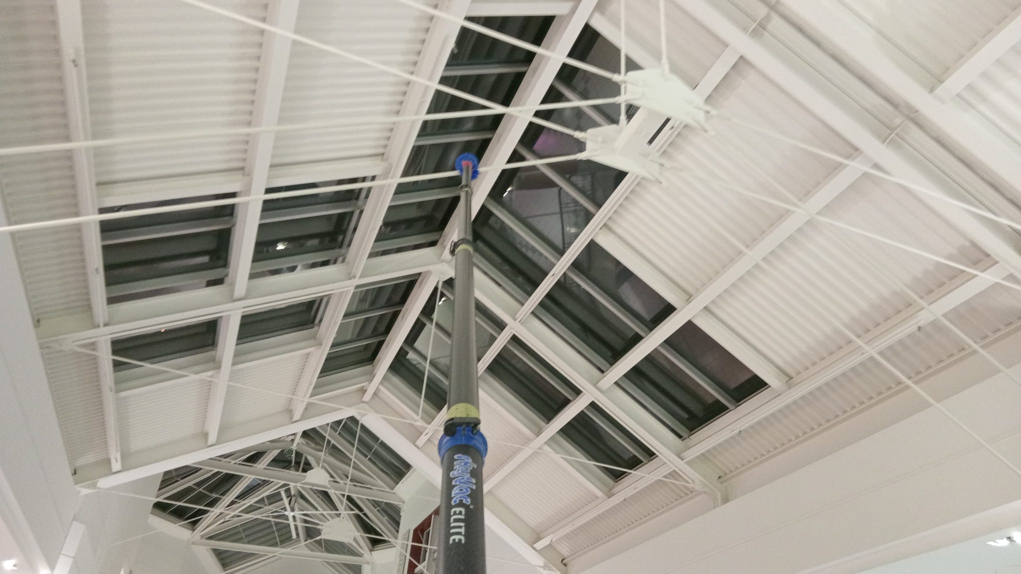 High reach pole extended to a skylight and steel truss ceiling at Mapleview Mall in Burlington