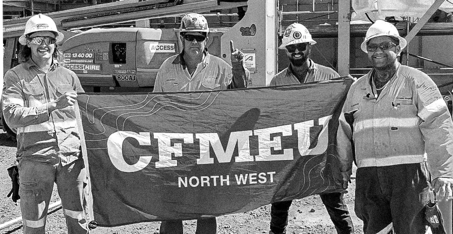 CFMEU North West members holding a union flag on site