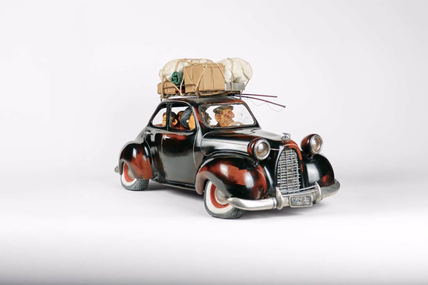 Guillermo Forchino sculpture of a vintage black car piled high with luggage