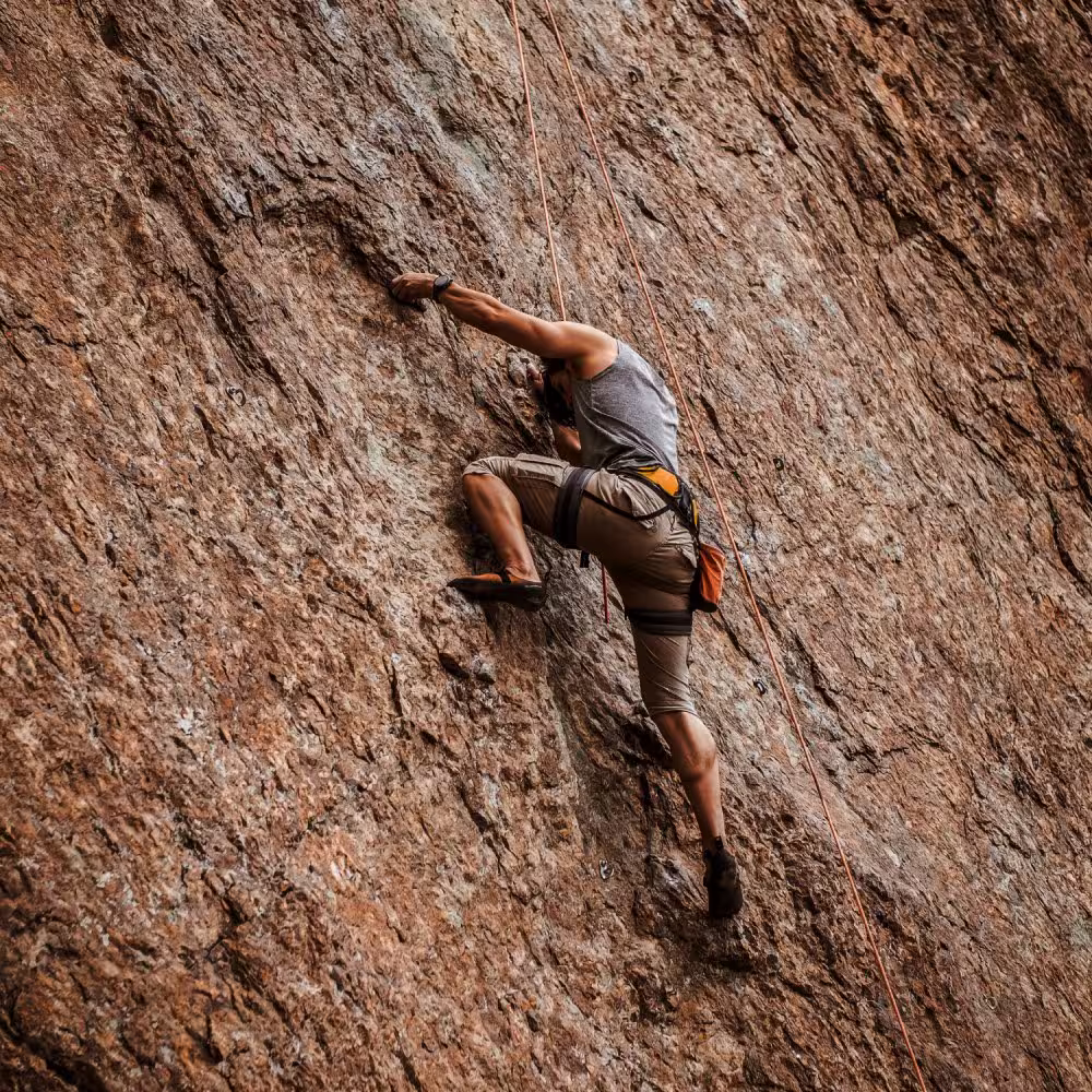 Rock climber ascending a rock face