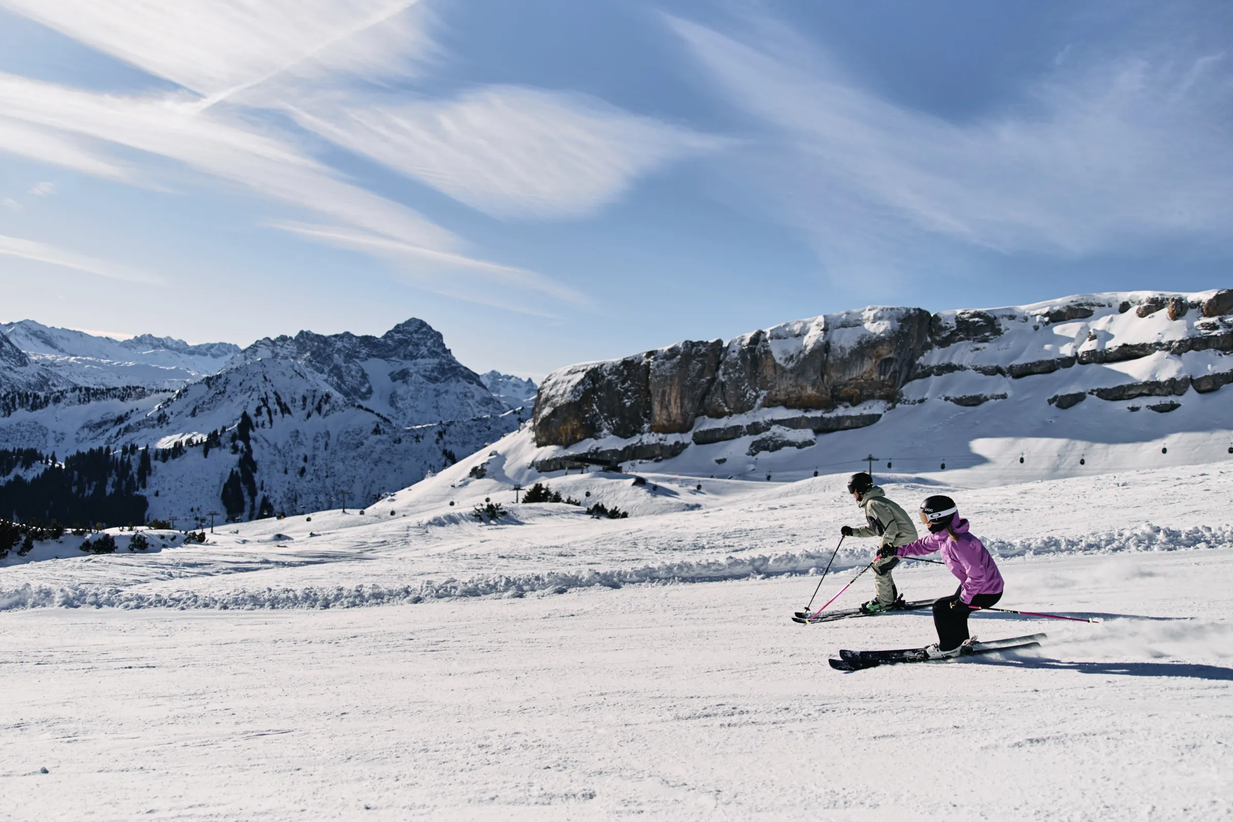 Skifahrer mit Kind auf der Piste am Ifen bei blauem Himmel