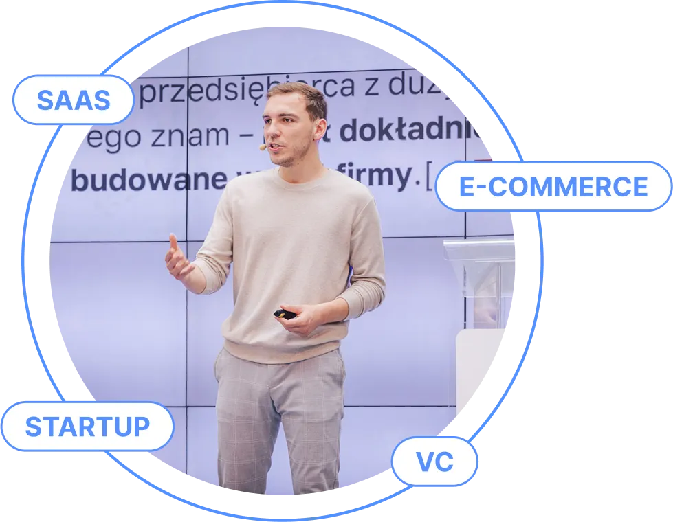 Robert Grygorowicz podczas prezentacji, w otoczeniu haseł SaaS, e-commerce, startup i VC