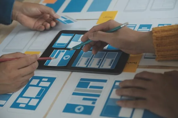 People working on user interface design with wireframes and a tablet showing layout prototypes.