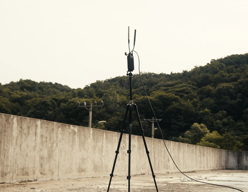 Neros Crossbow Ground Control Station set up in concrete lot in front of forest. 