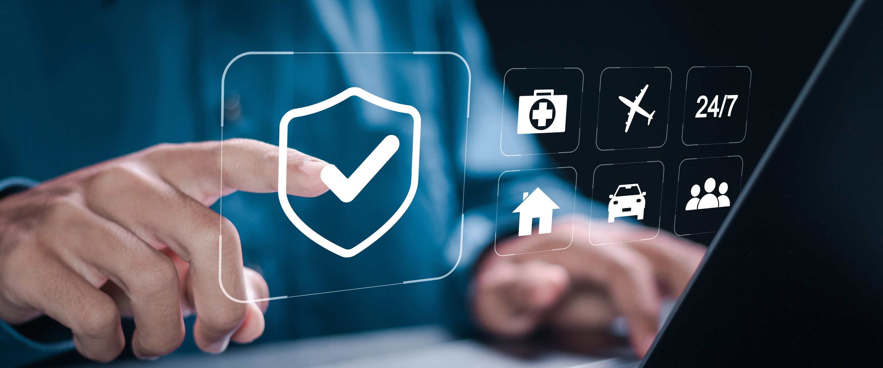 Hand at a laptop with insurance coverage icons