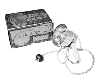 Vintage Gillette Electromatic hair dryer with its original labeled box, featuring a bulbous nozzle and a coiled power cord with a plug.