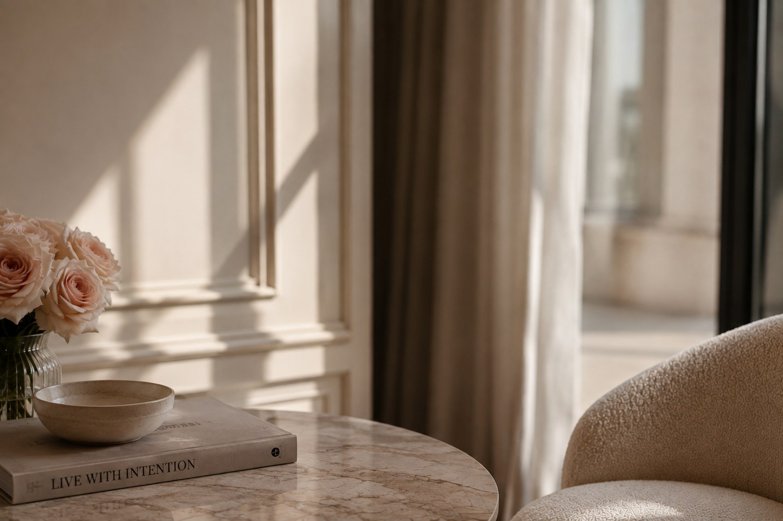 A marble side table with roses in morning sunlight