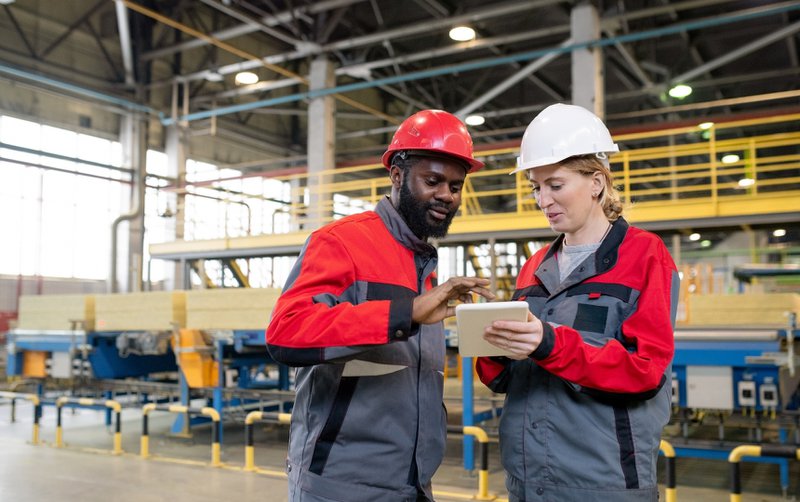 Coworkers discussing manufacturing issues