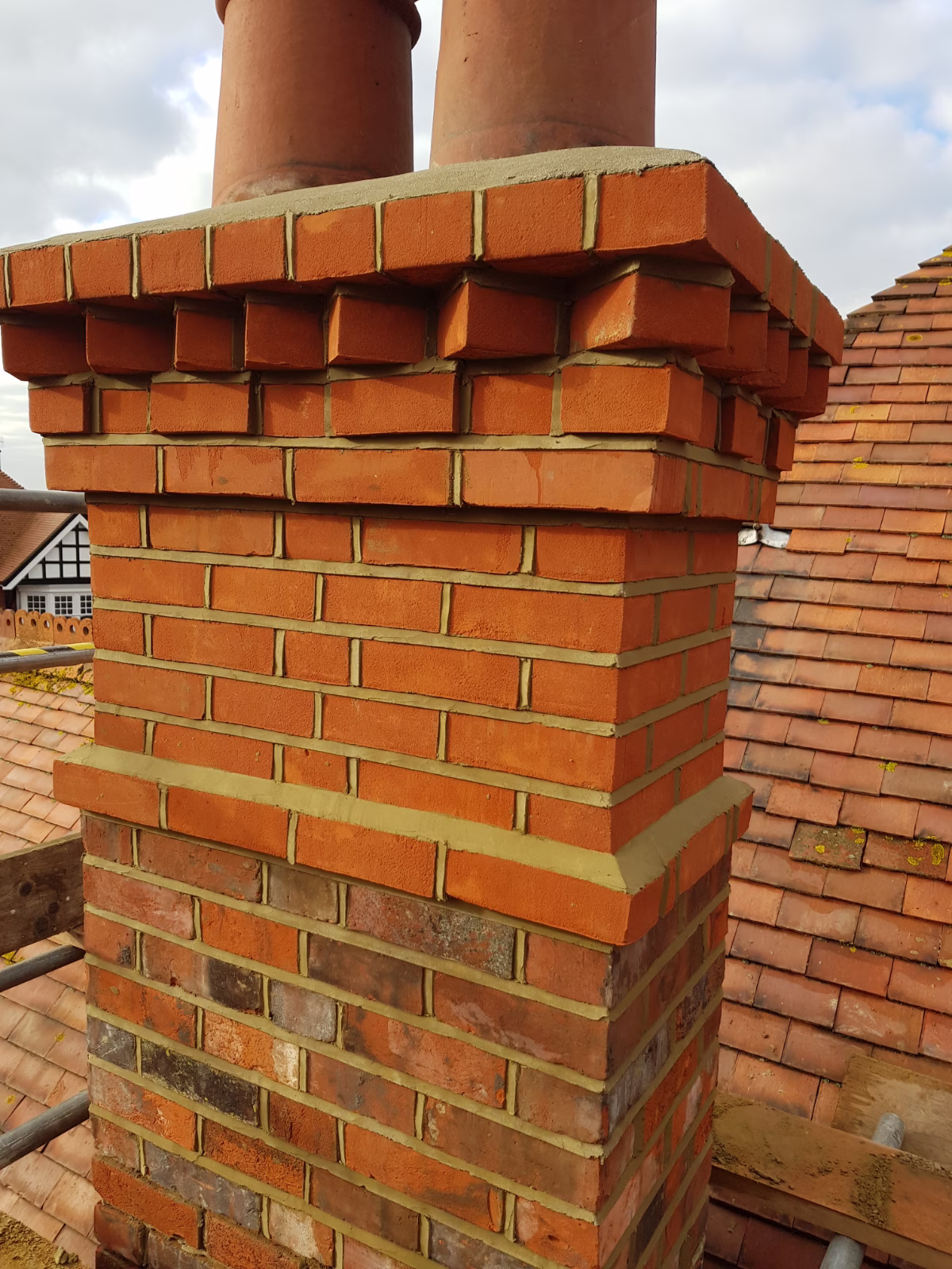 Rebuilt and repointed brick chimney stack in Lancing