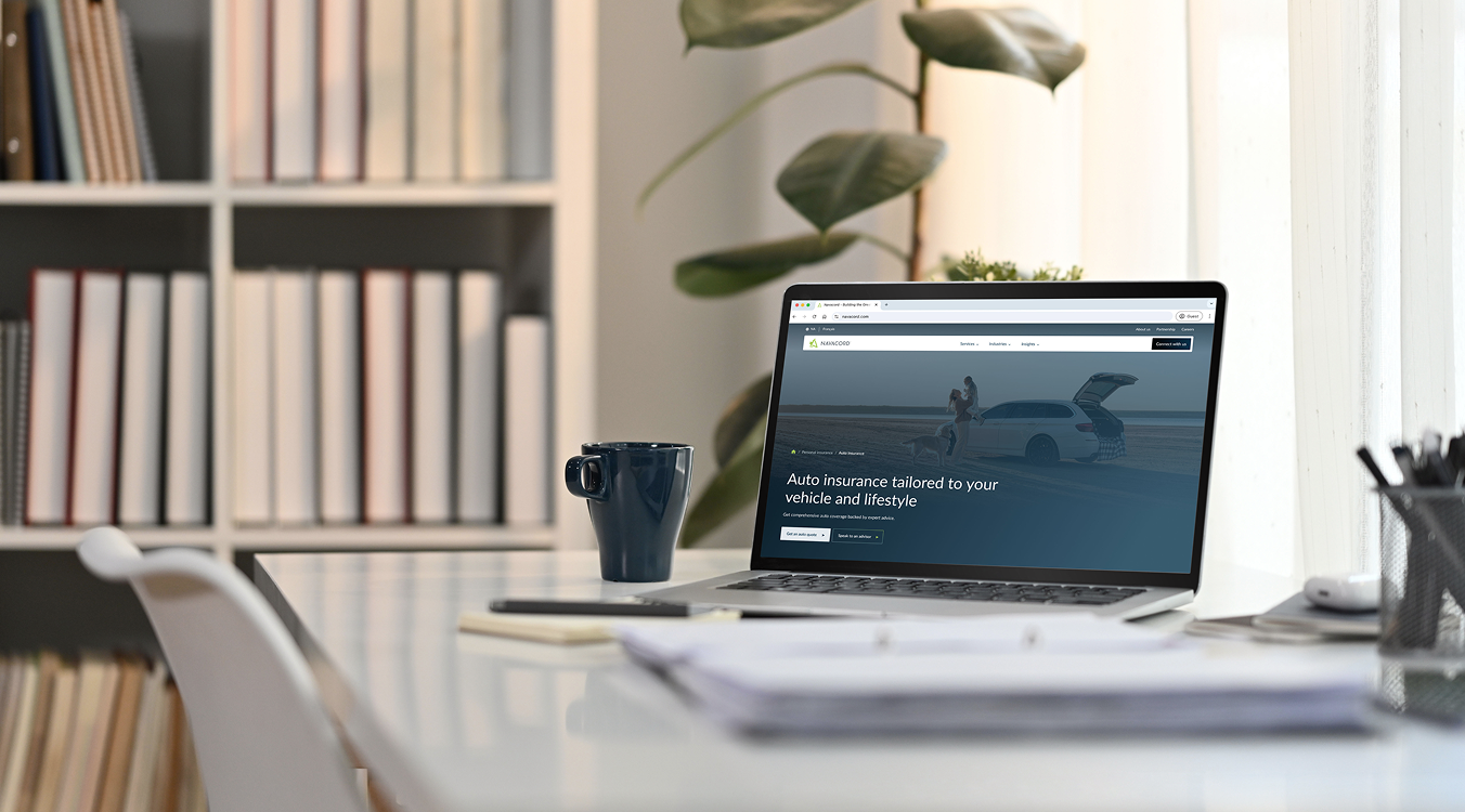 A user's laptop displaying the Navacord auto insurance page, a successful project by our insurance web design agency.