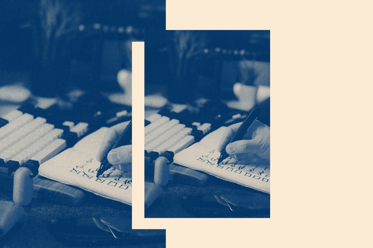 Hand writing in a planner checklist on a desk