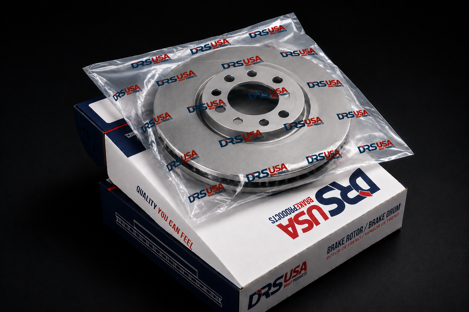 Rotor de freno nuevo, empaquetado en bolsa transparente con impresión de logo DRS USA, colocado sobre caja blanca y azul con la marca DRS USA y texto que dice "Brake Rotor / Brake Drum" y "Rotor de Freno / Tambor de Freno".