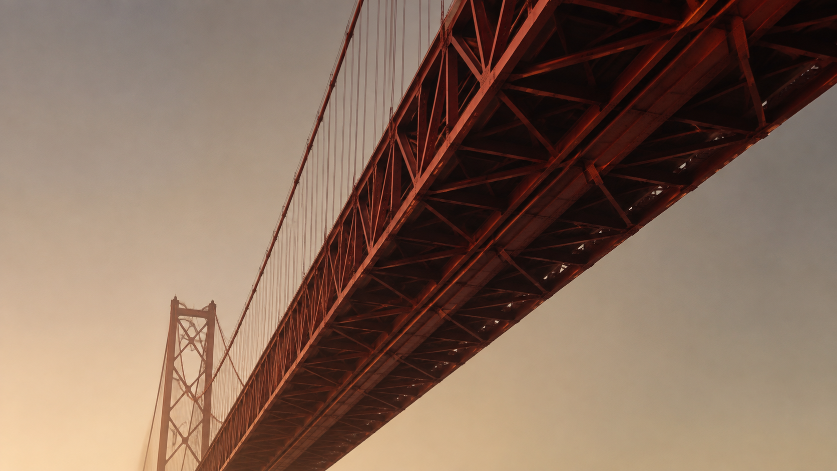 Suspension bridge in Lisbon viewed from below at sunset