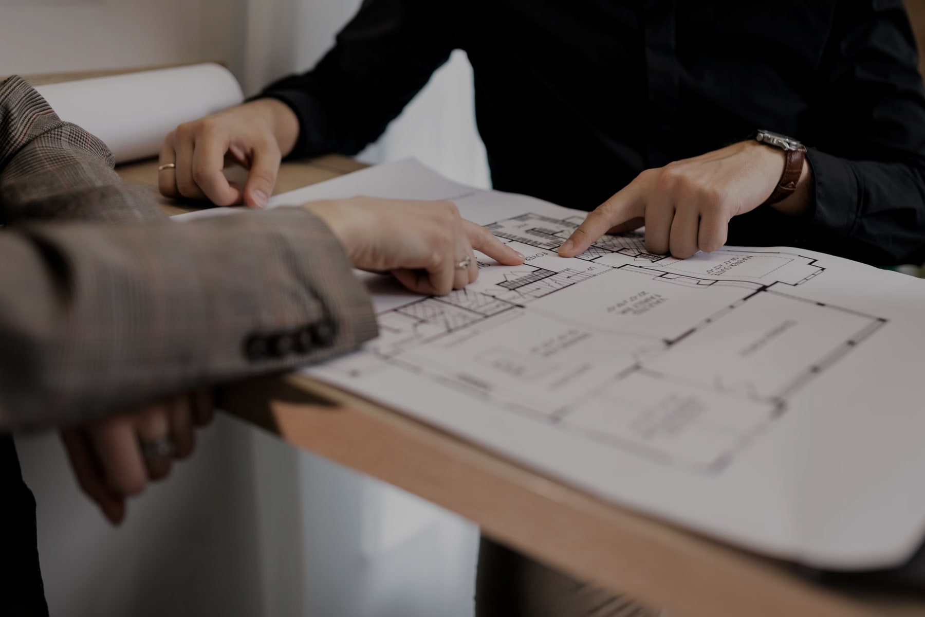 Professionals reviewing an architectural plan during a strategy and development session
