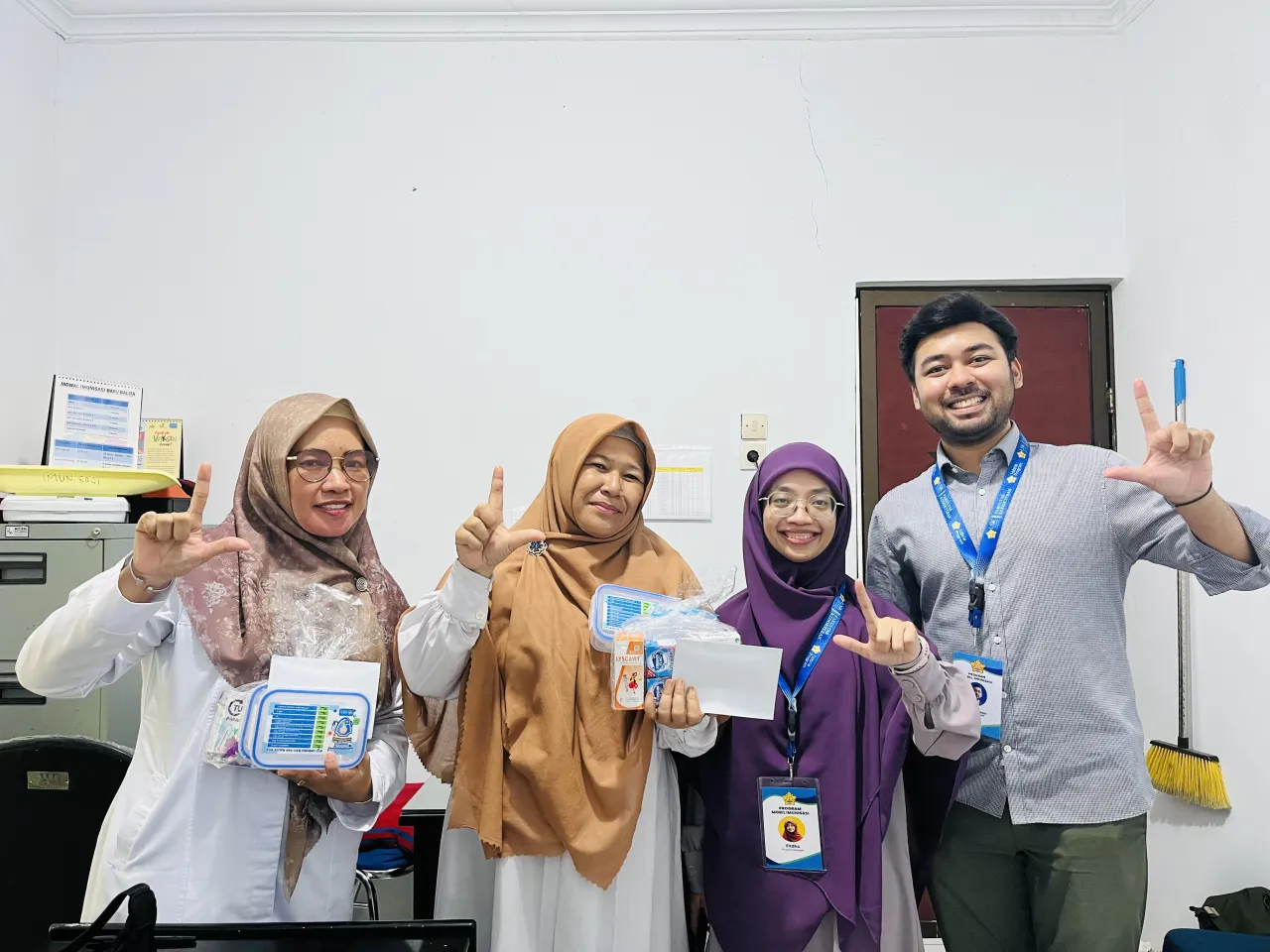 Group photo showing Abu Hasan Sajili and his partners at a clinic in Indonesia 