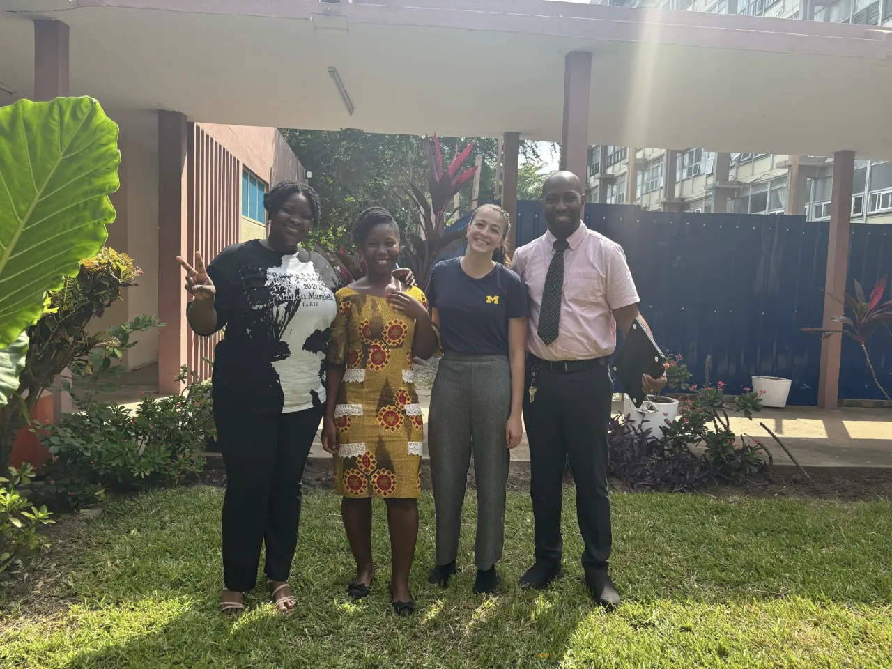 Researchers pose for a group photo in a garden. 