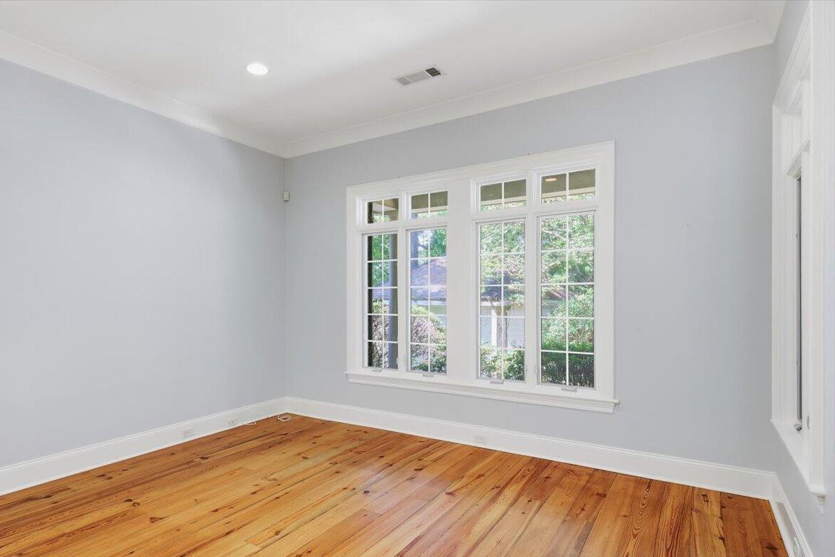 Main-level room with heart pine floors and a large window