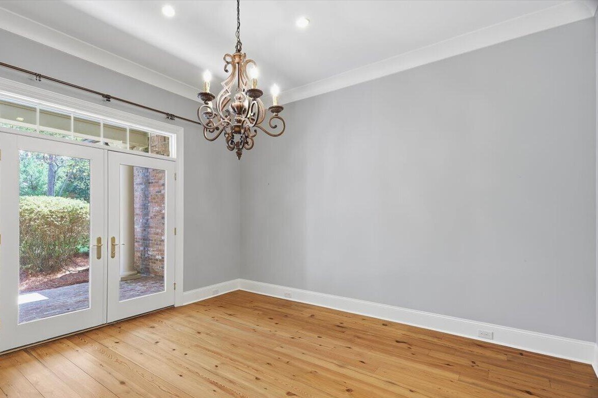 Dining room with chandelier and French doors to the porch