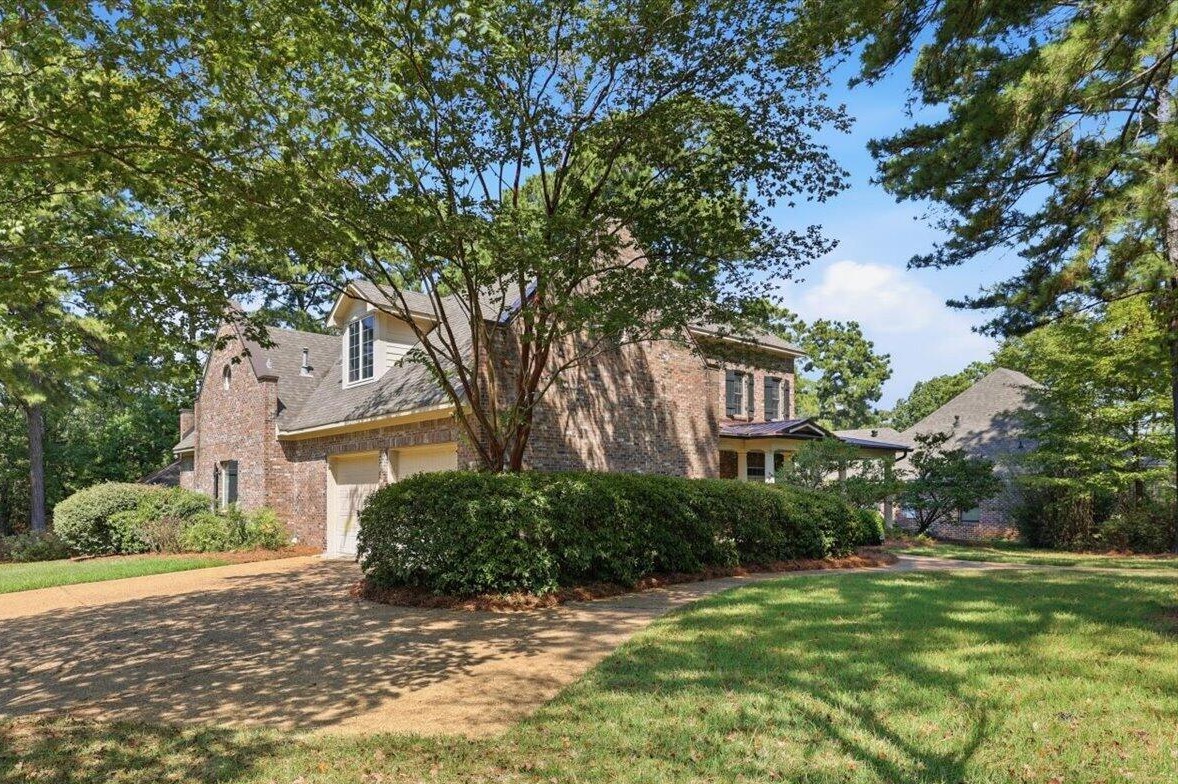 Corner lot view of the brick home and landscaped yard in Knightsbridge