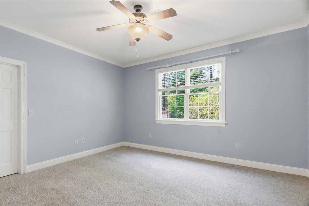 Upstairs bedroom with carpet and ceiling fan