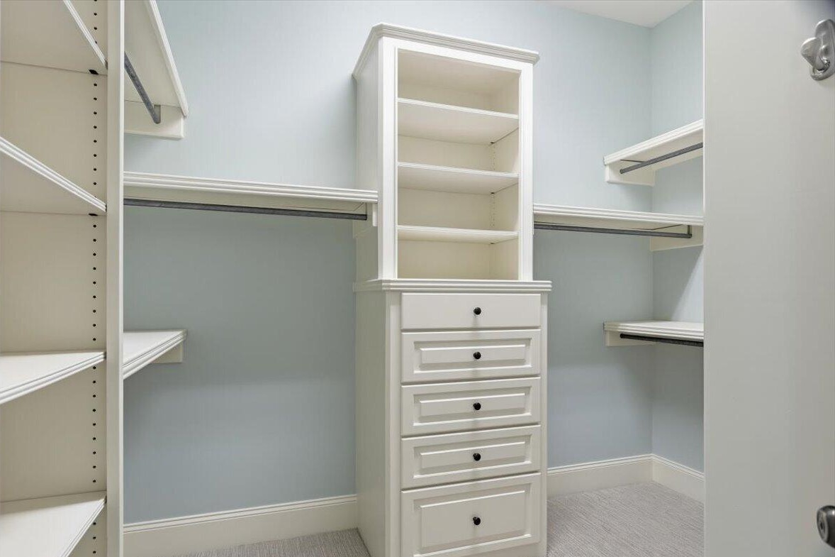 Walk-in closet with built-in shelves and drawers