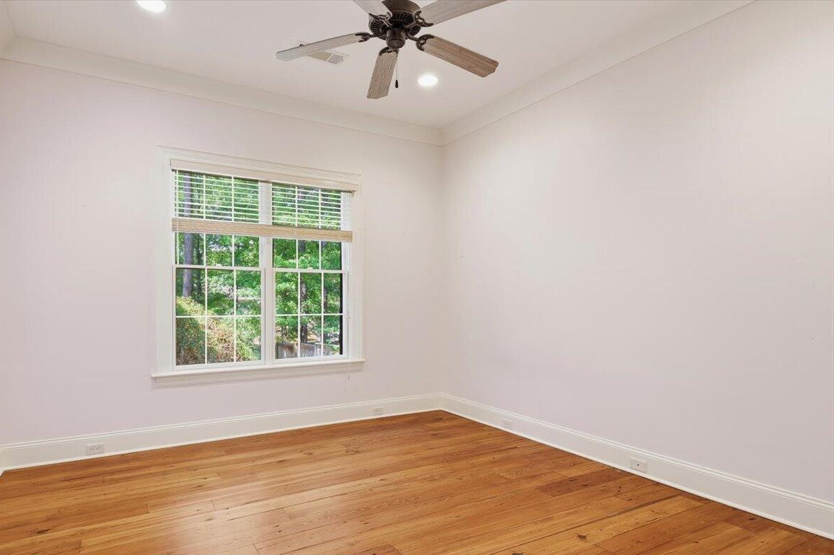 Bedroom with heart pine floors and ceiling fan