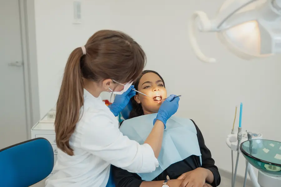 emergency-dentist-in-plainsboro-examining-womans-teeth-during-exam