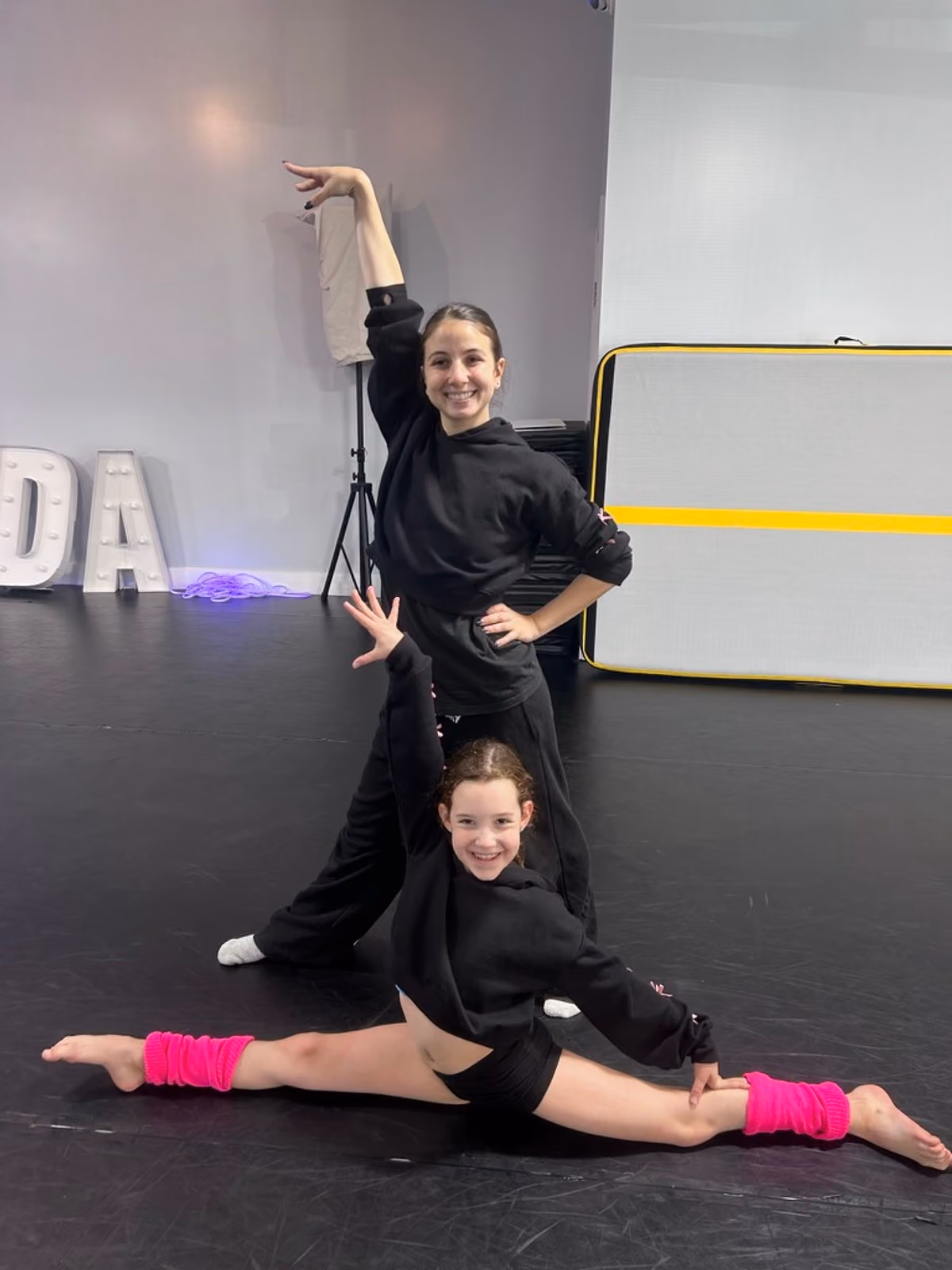 Two dancers posing in the studio at Revolution Dance Academy