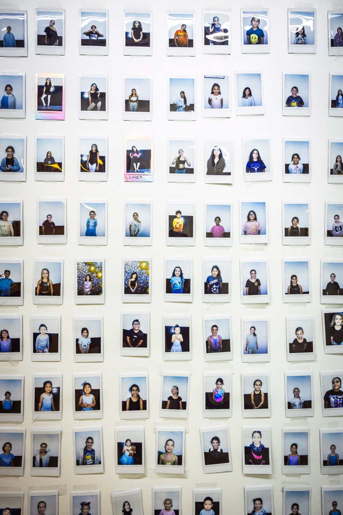 Wall of dancer portraits at Revolution Dance Academy