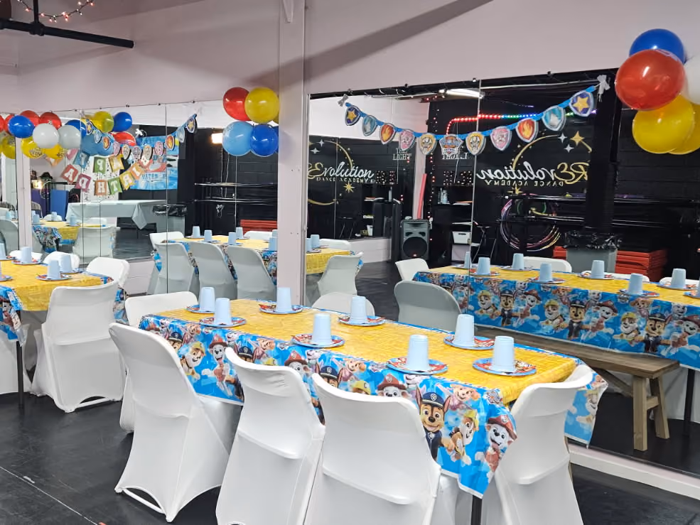Dance studio decorated with balloons, banners and party tables for a birthday celebration at RDA