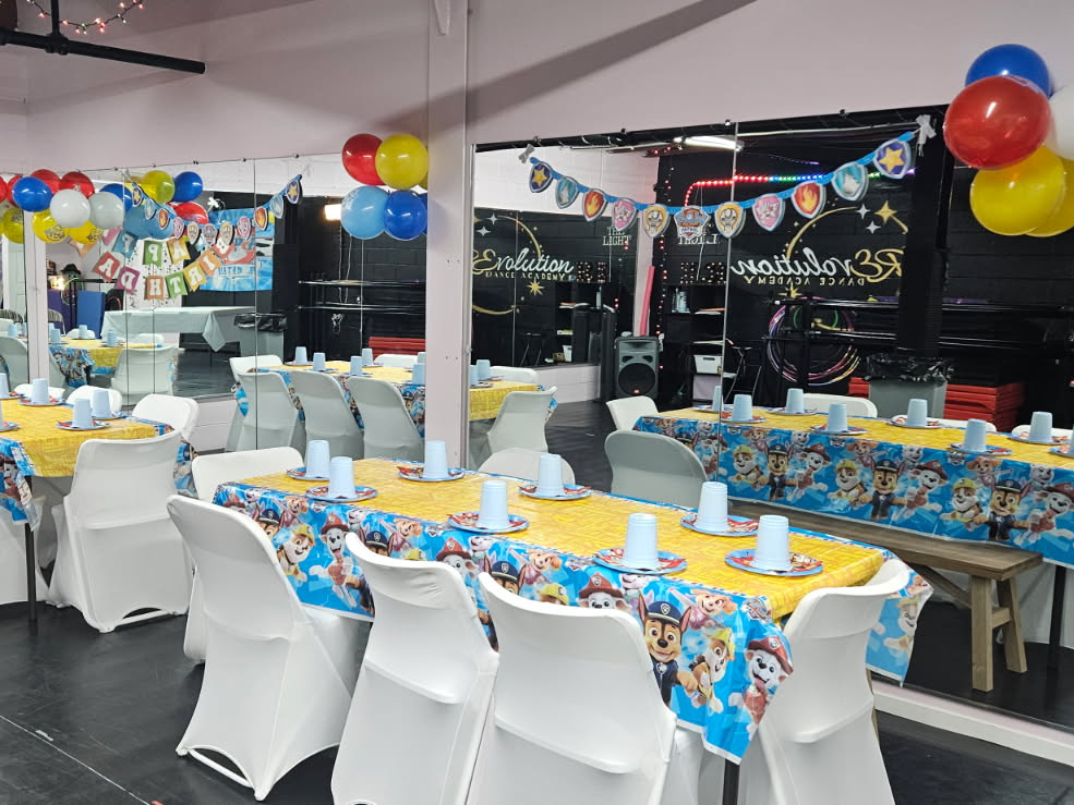 Dance studio decorated with balloons, banners and party tables for a birthday celebration at RDA