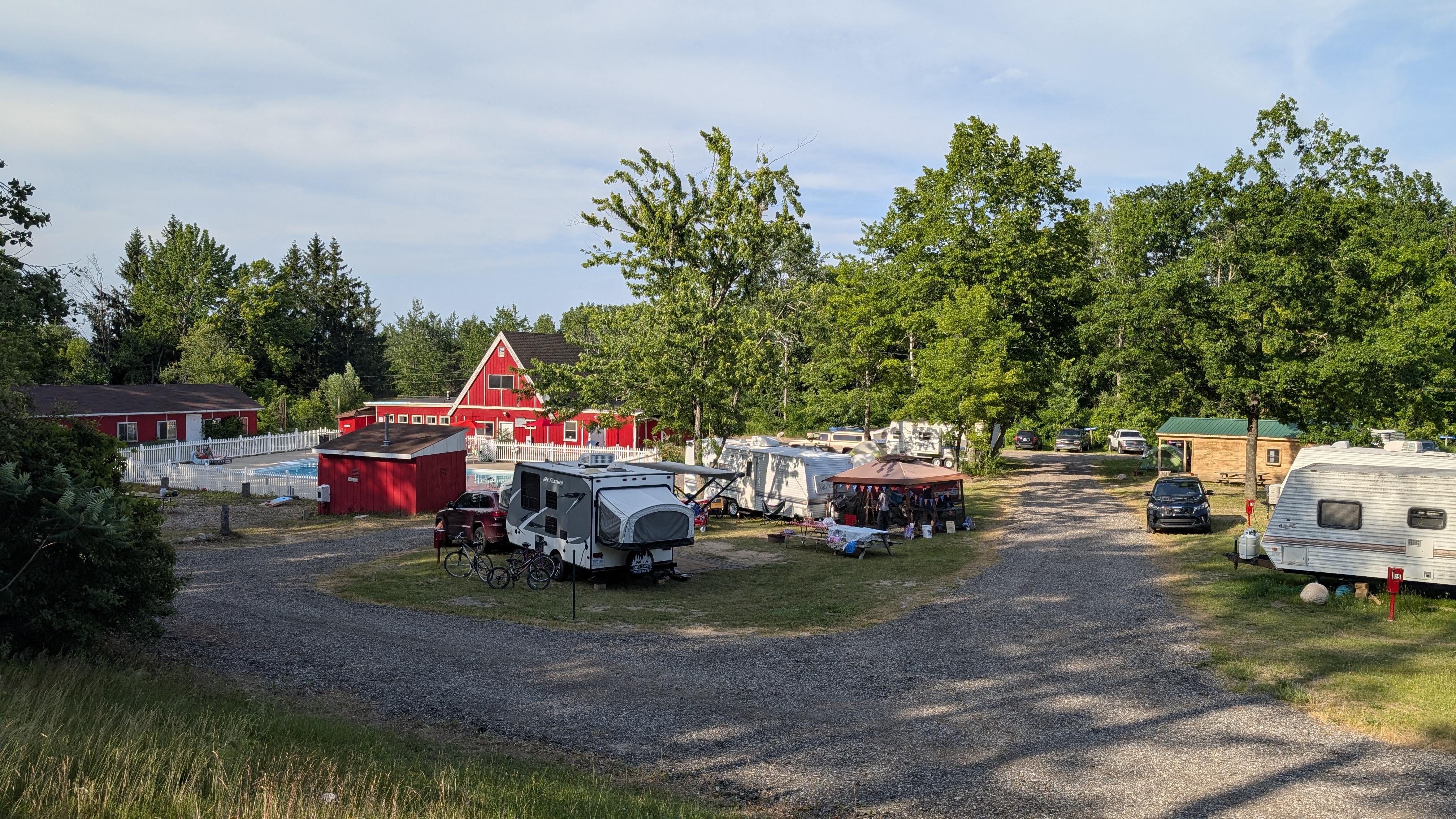 Aerial view of Paul Bunyan Campground showing the pool, red camp store, and RV sites among the trees