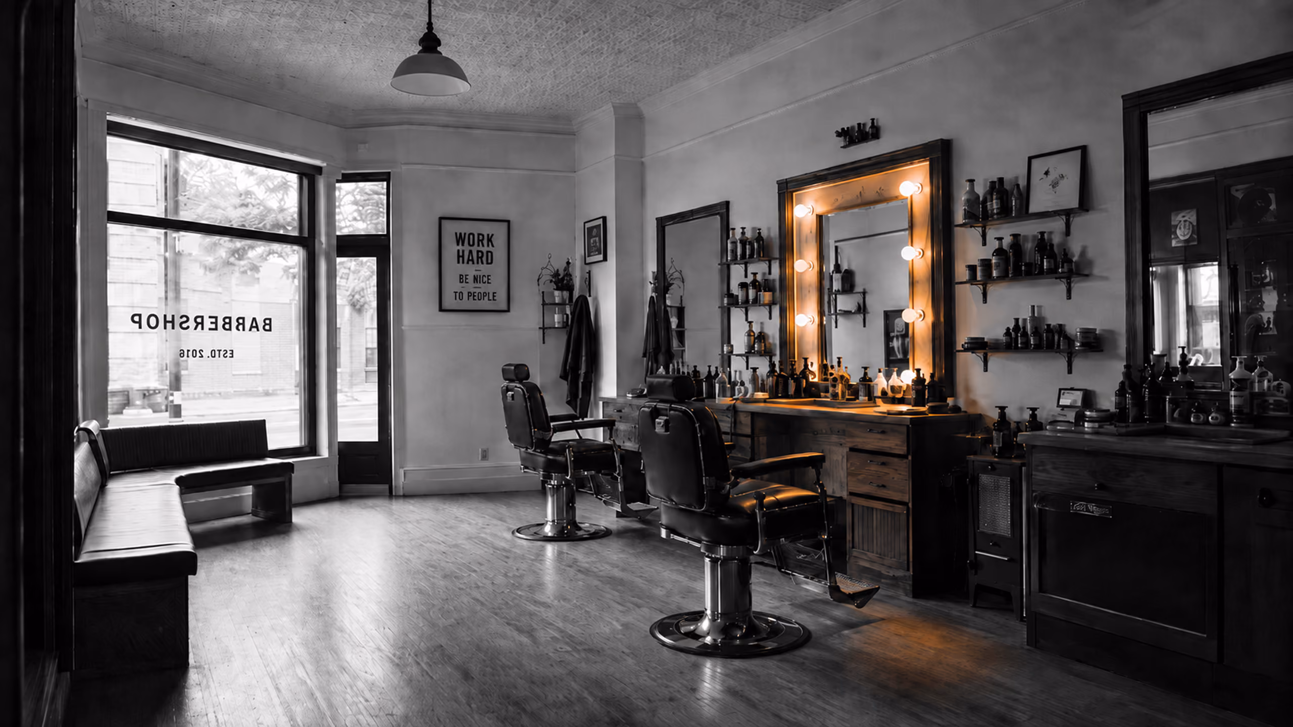 Independent barbershop with one warmly illuminated barber station.