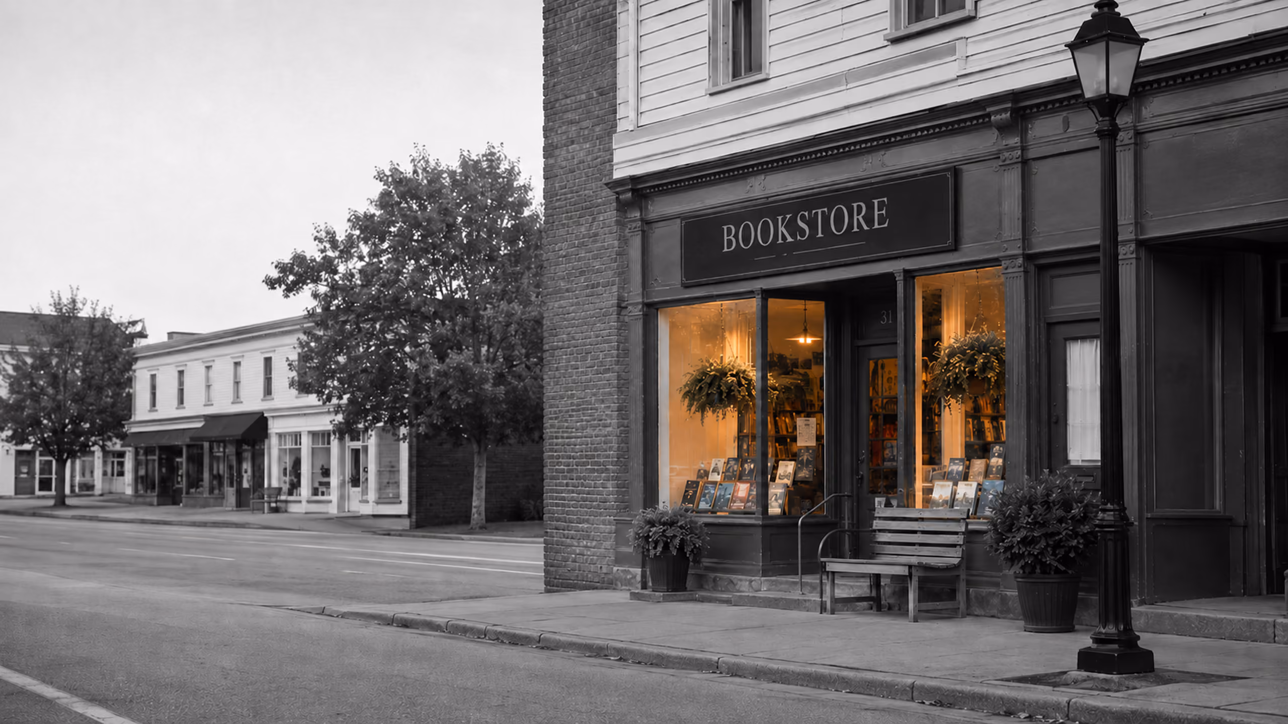 Independent bookstore with warmly illuminated window displays on a quiet main street.