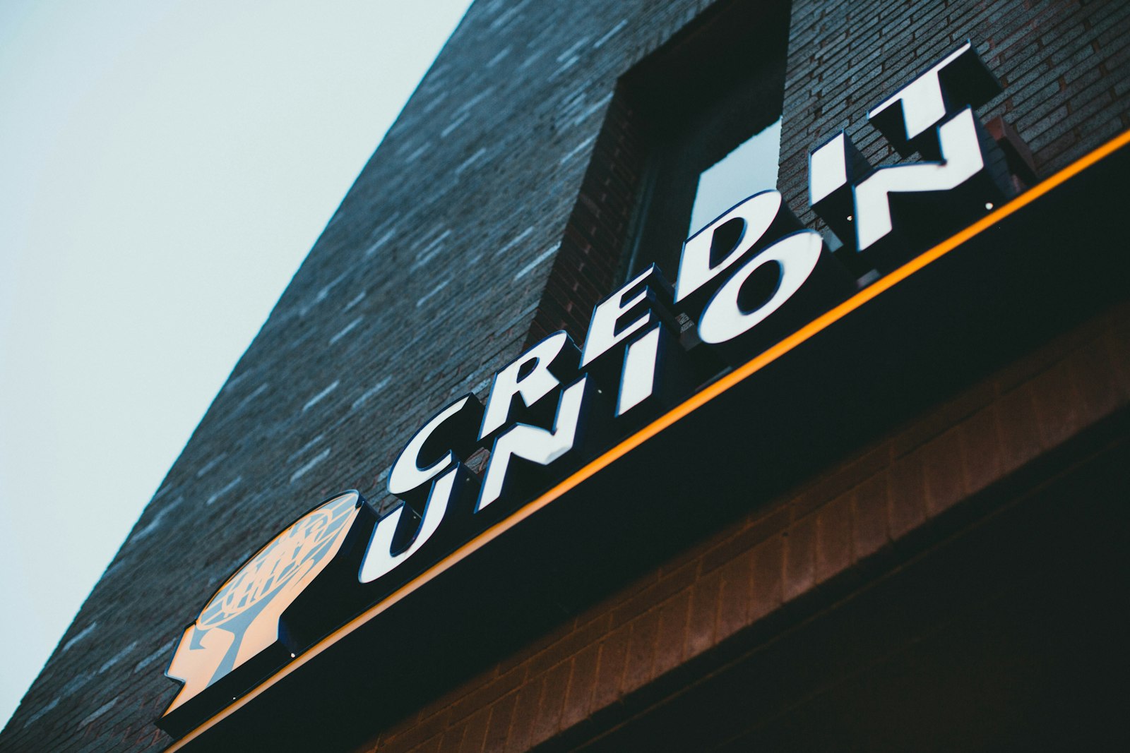 Credit union sign on the side of a brick building