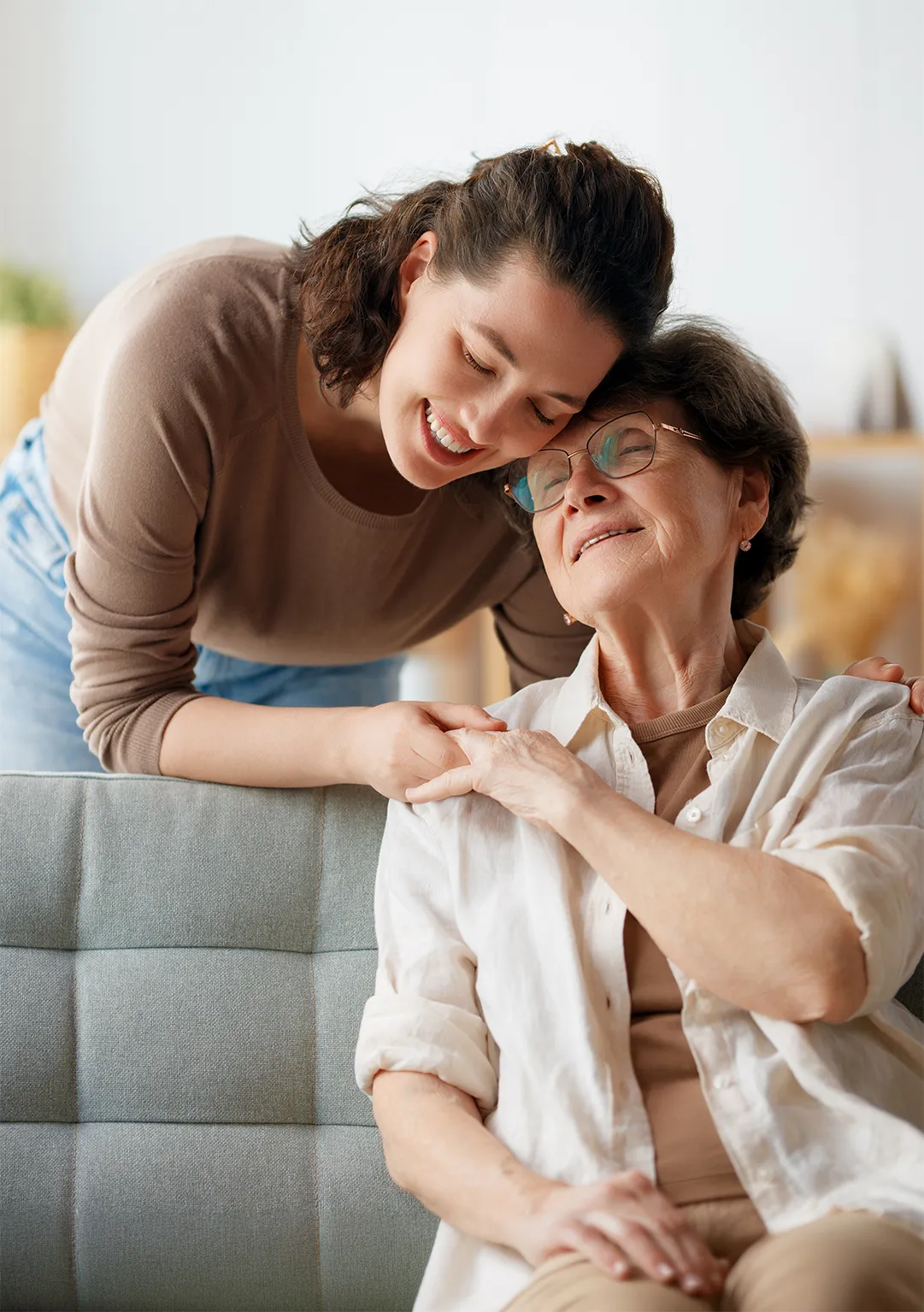 Volunteer embracing an elderly woman