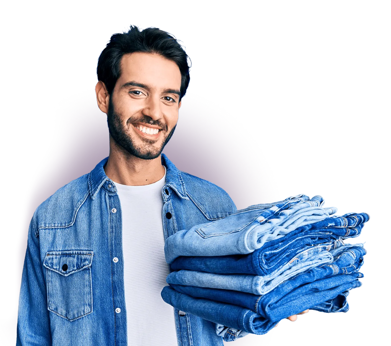 Man holding folded jeans at Poverello Thrift Store