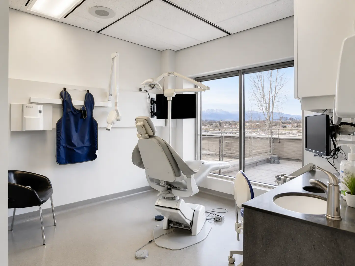 Bright treatment room with a mountain view at Macleod Trail Dental