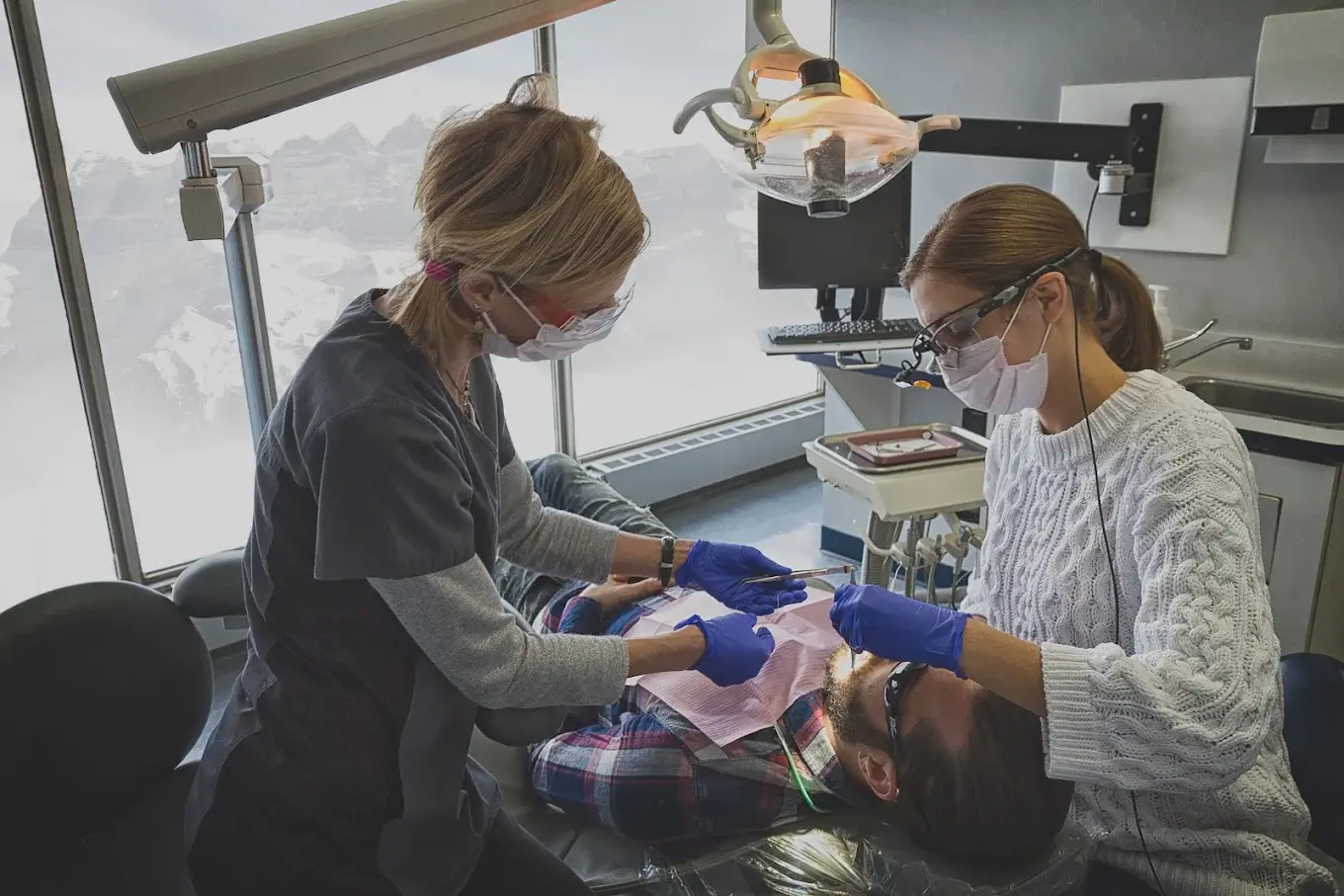 Dentist and assistant treating a patient at Macleod Trail Dental in Calgary