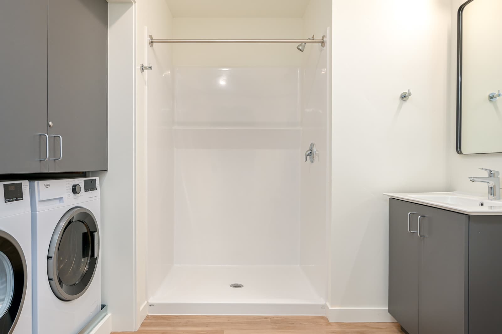 Bathroom with shower and washer and dryer