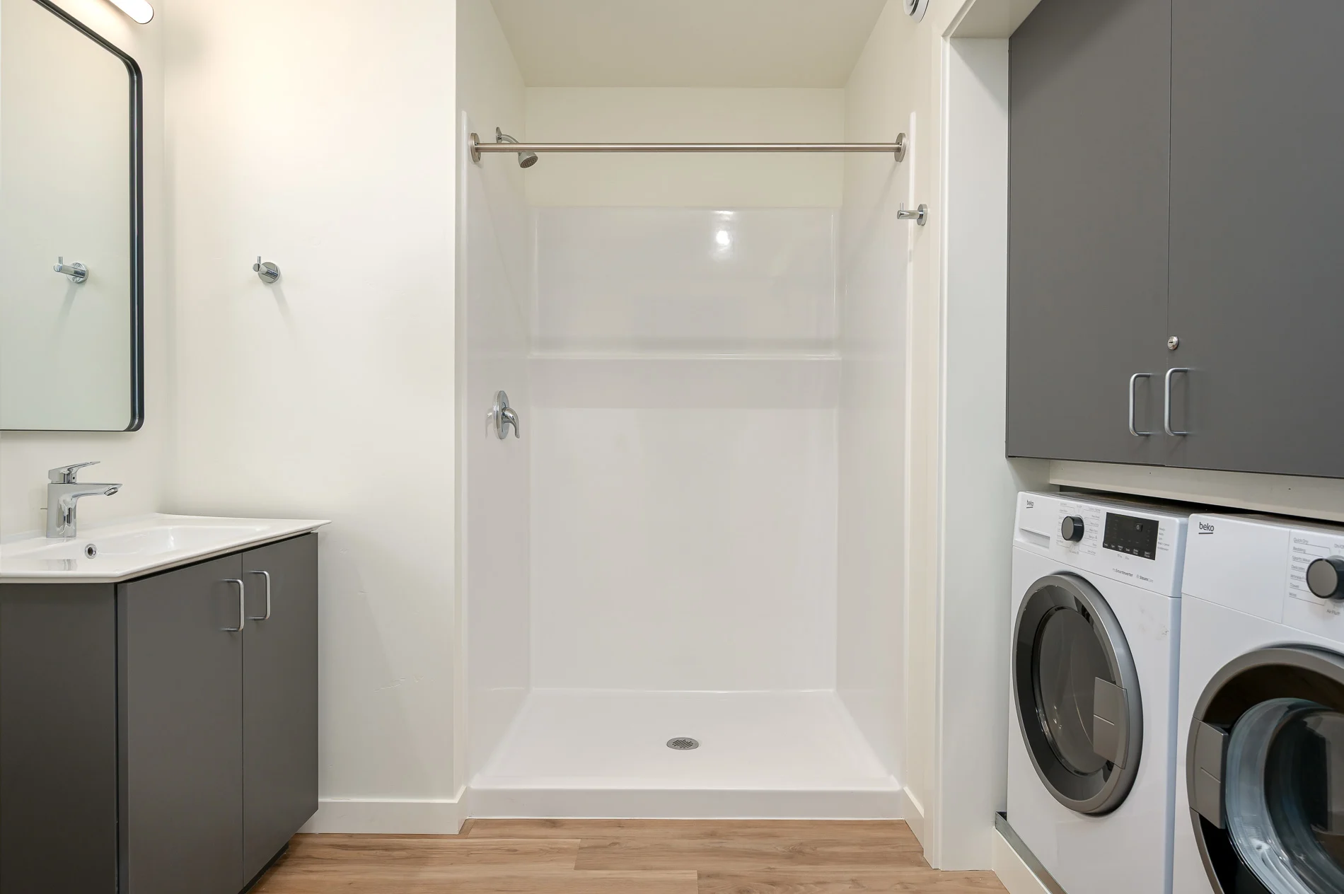 Bathroom with shower and washer and dryer