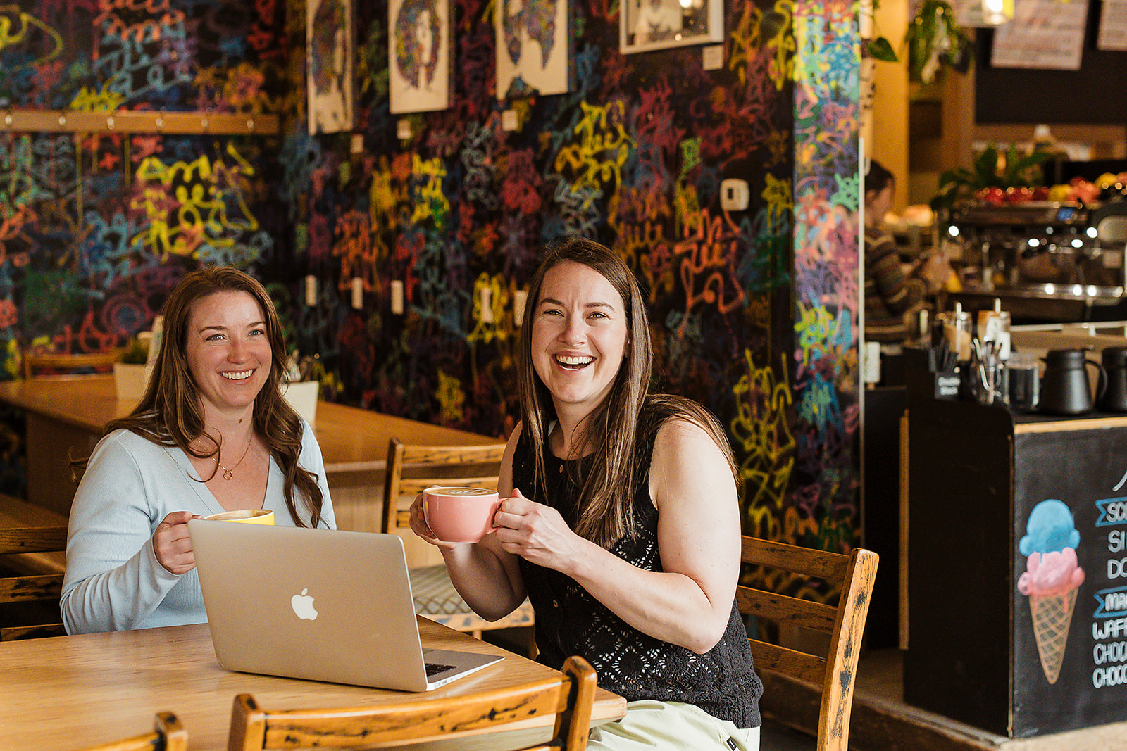 Meagan and Glynnis of Cadence Accounting working over coffee at a local cafe